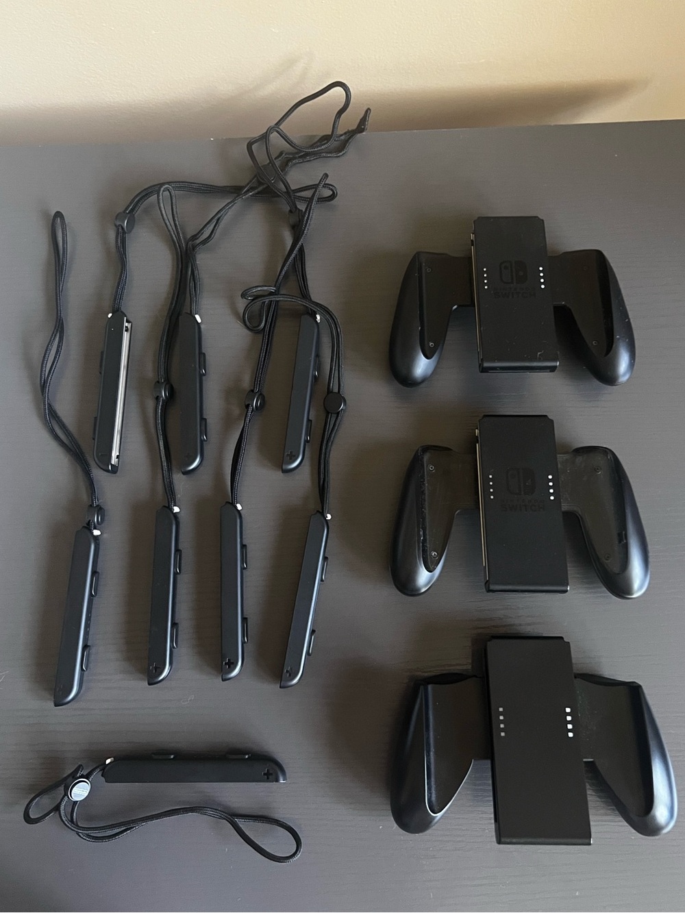 Nintendo Switch Joy-Con comfort grip and a black Joy-Con wrist strap. Used